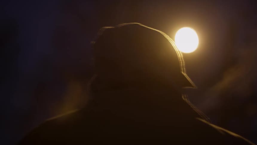A person is traveling outside at night