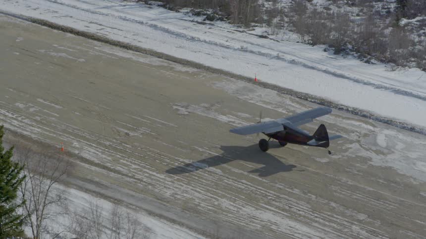 A plane is landing in the snow
