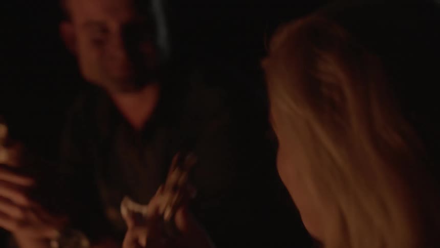 Friends are eating around a campfire
