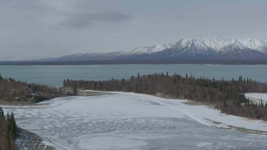 The snow has fallen on this field next to a lake