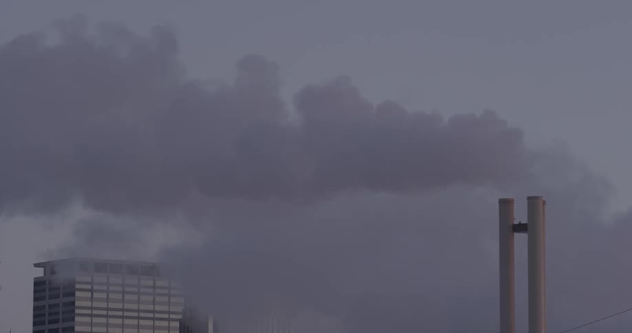 Smoke billows from a smokestack
