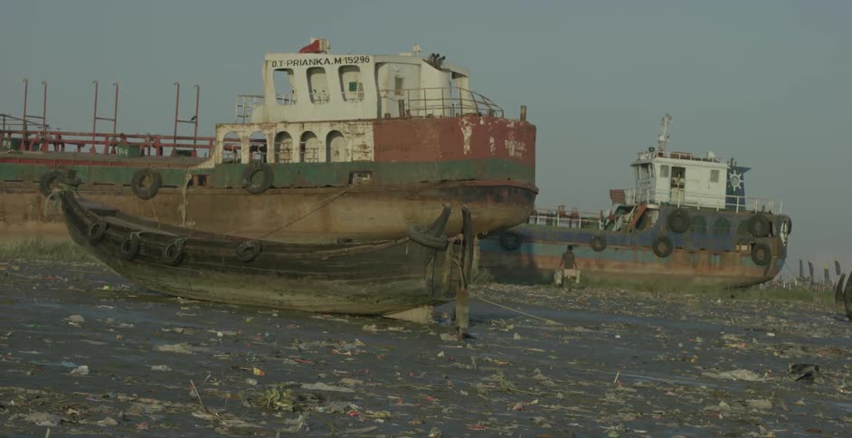 A man walks towards a parked barge