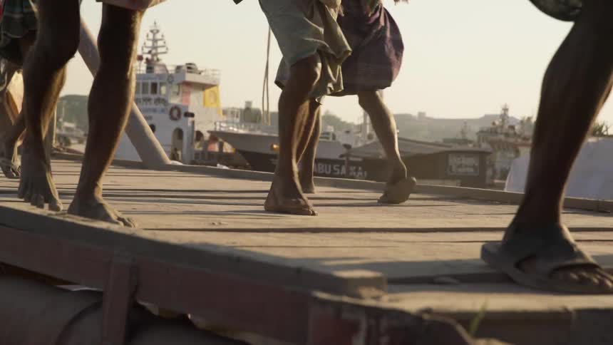 People walk barefoot on a dock