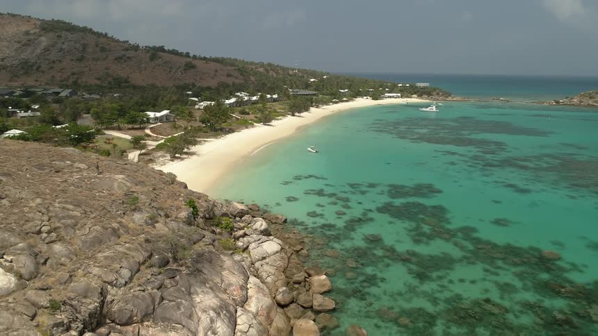 The beach stretches out along the blue green crystal clear sea