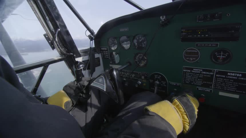 A pilot in the cockpit of a small plane