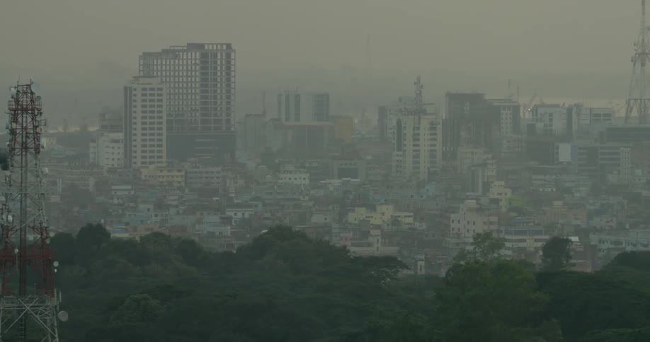 A dense city on a foggy day