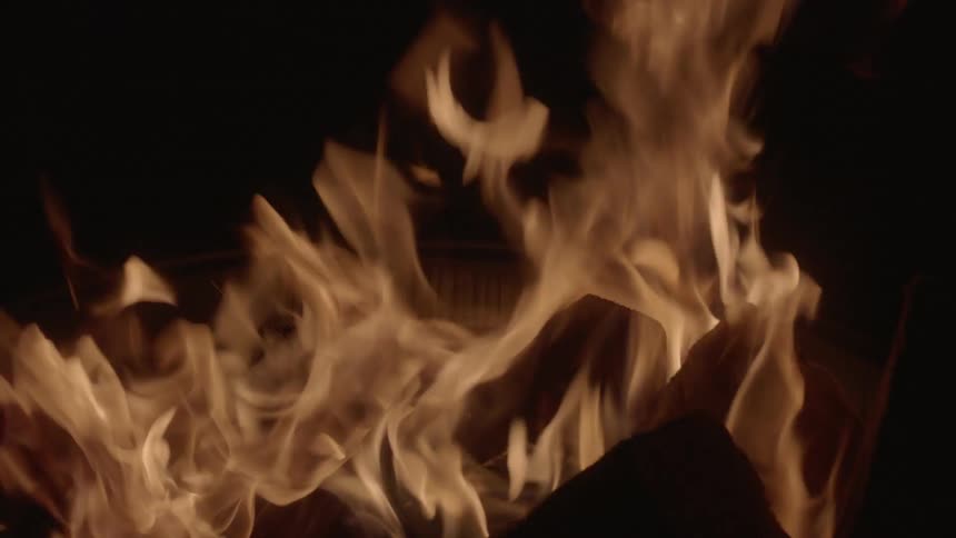 Logs in a fireplace burn brightly