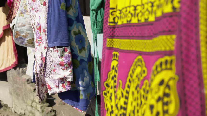 Tapestry hangs on clothesline on a sunny day