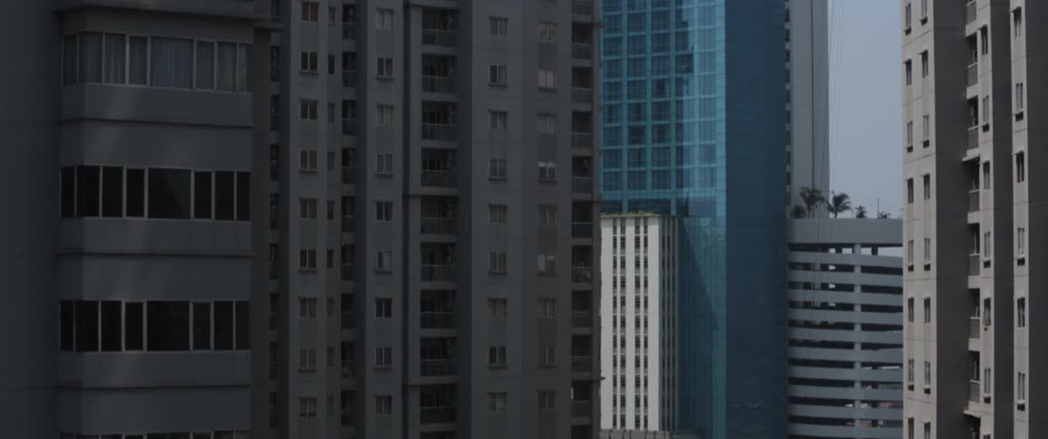 A tall residential building in a city during the day