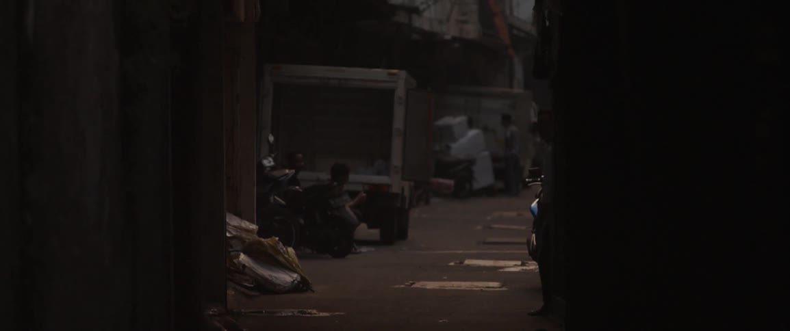 Several people loitering in an alleyway