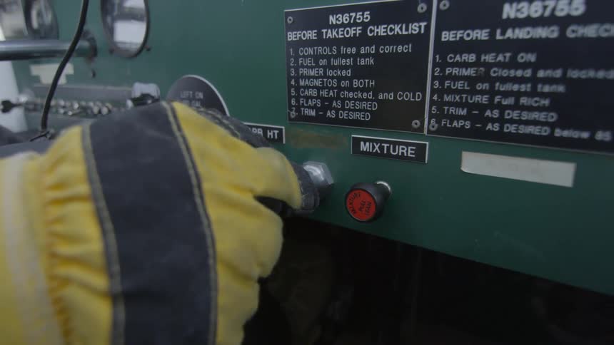 A person wearing yellow gloves