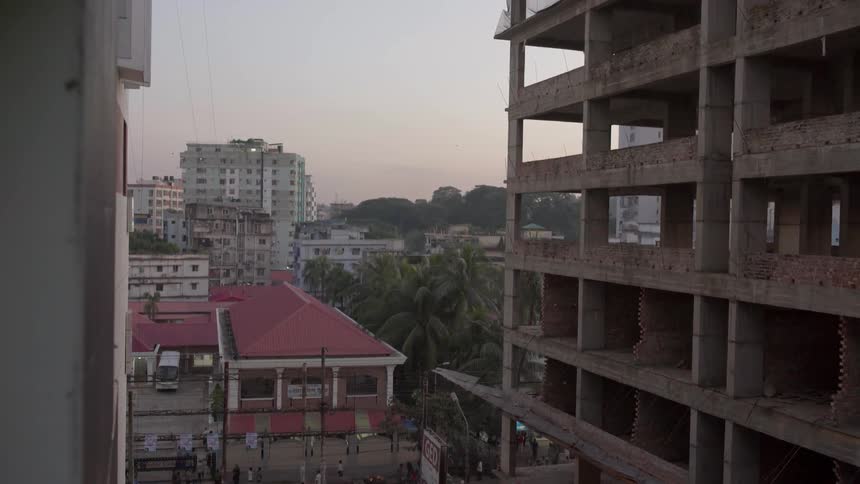 City buildings are shown at sunset