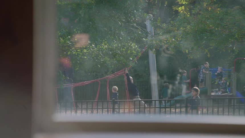 Children playing on a playground in the distance