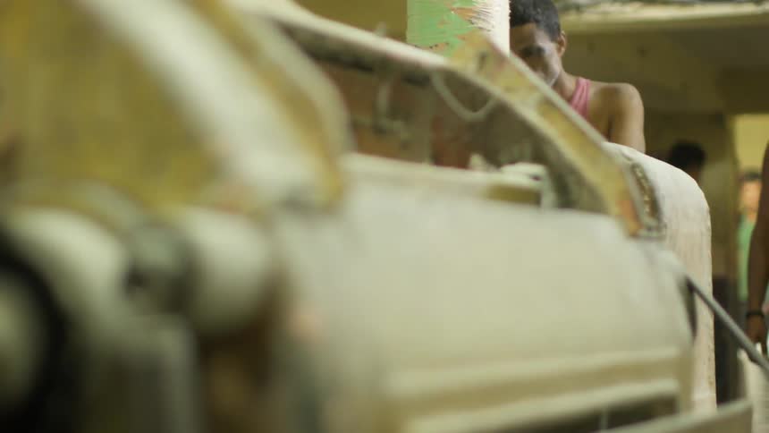 A man is working on a factory machine