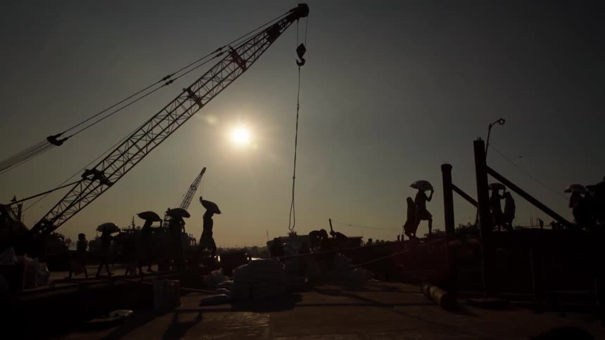 Construction workers work on a barge outdoors