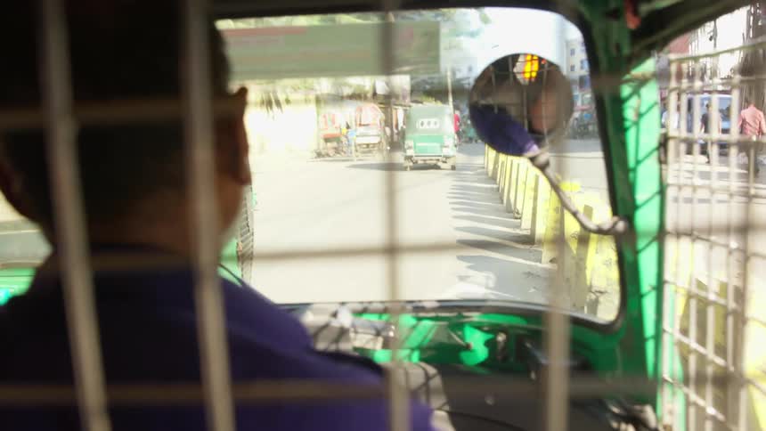 Taxi vehicles travel down a busy road