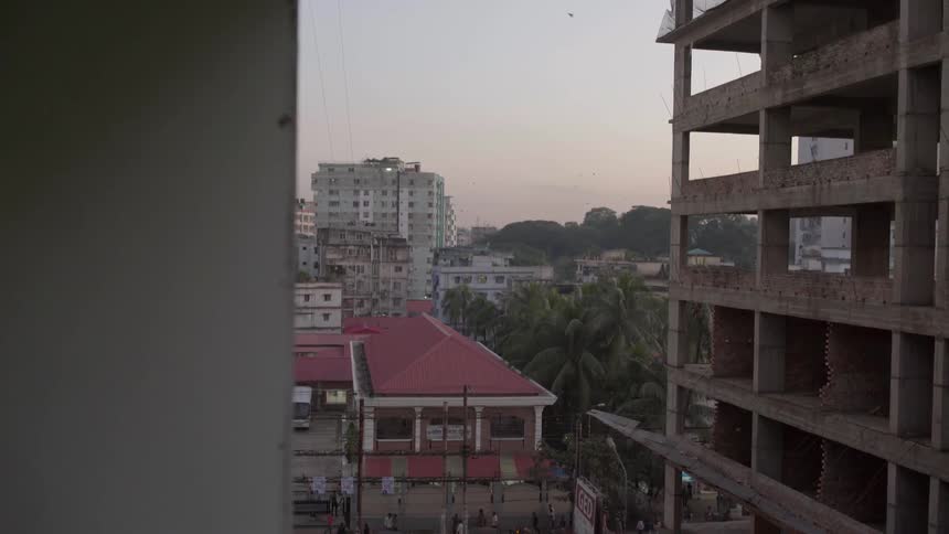 City buildings are shown at sunset