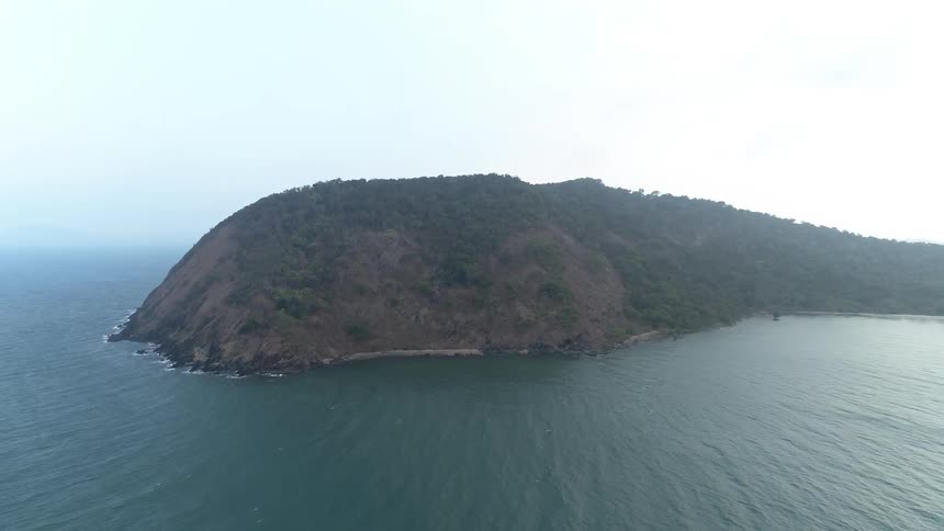 Large island in the ocean on overcast day