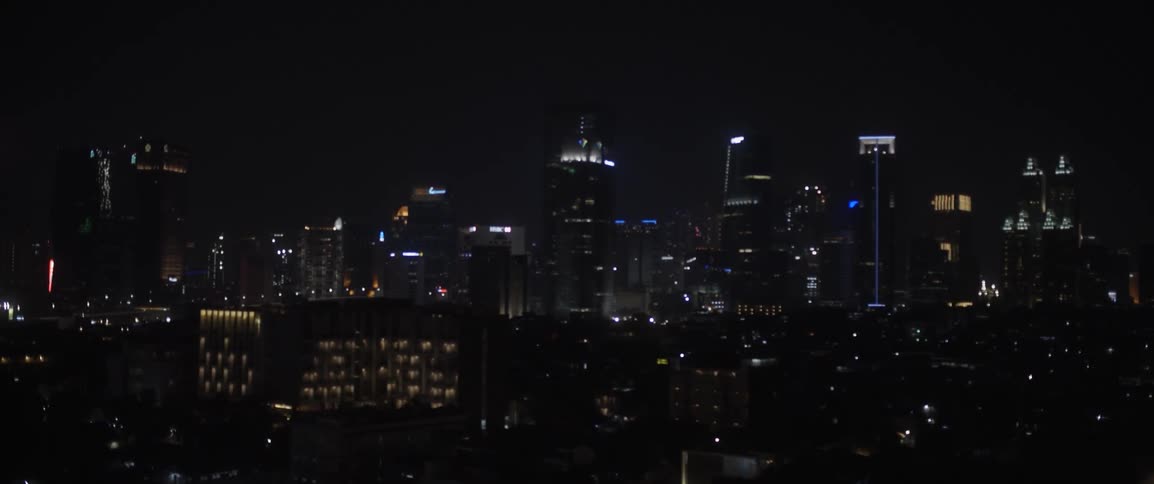 City buildings illuminate the night sky