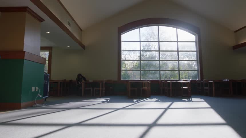 A man walks across a large room