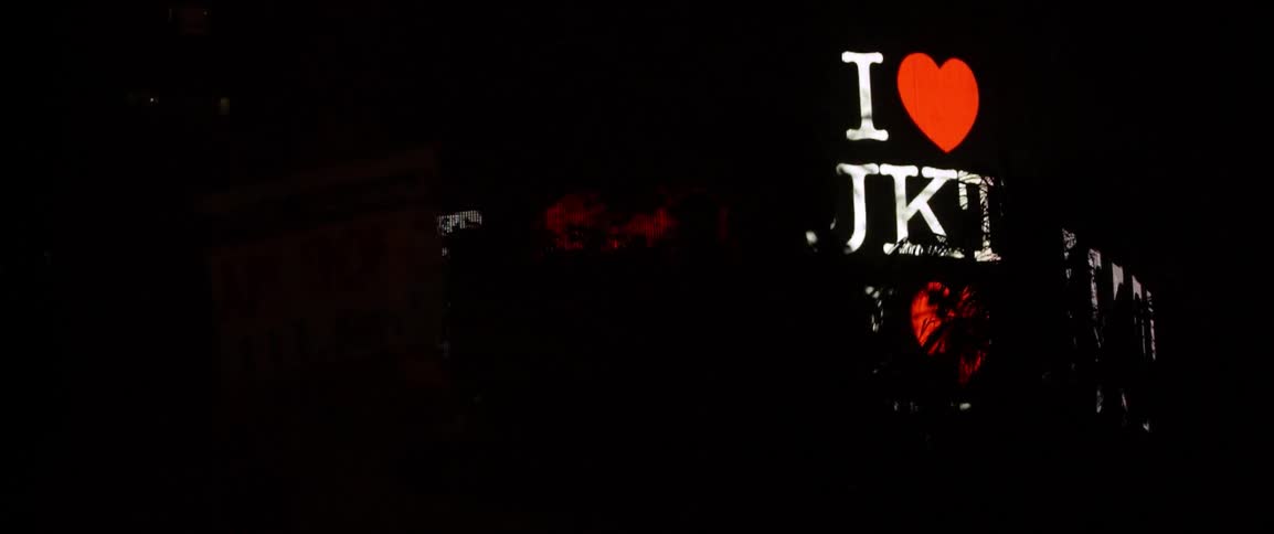 Flashing billboards illuminate the city sky at night