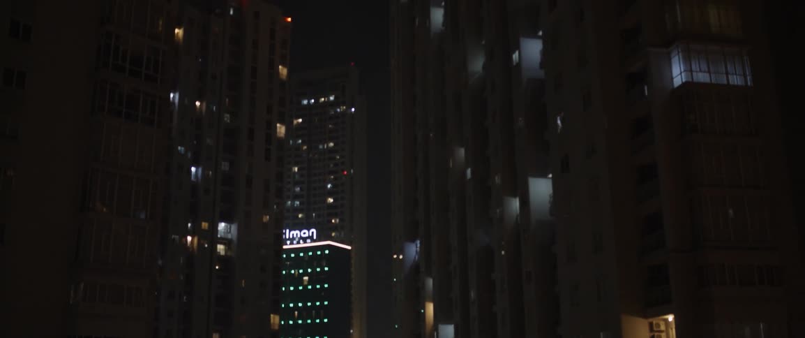 A city skyline at night taken from a window