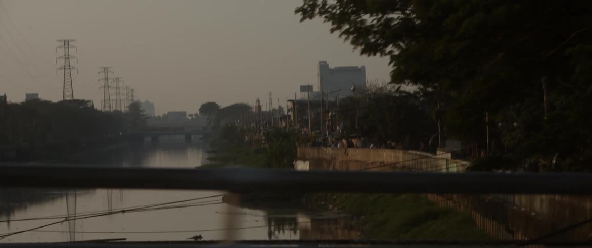 People walking on a bridge over a body of water