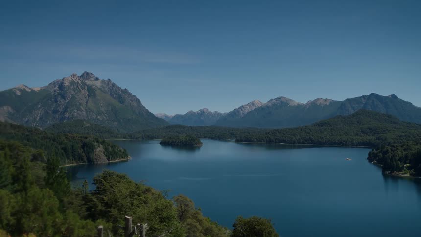View of a lake surrounded by trees and mountains