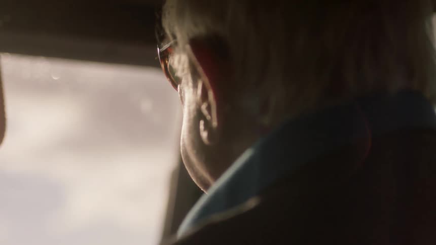 A man in a truck with the wipers going