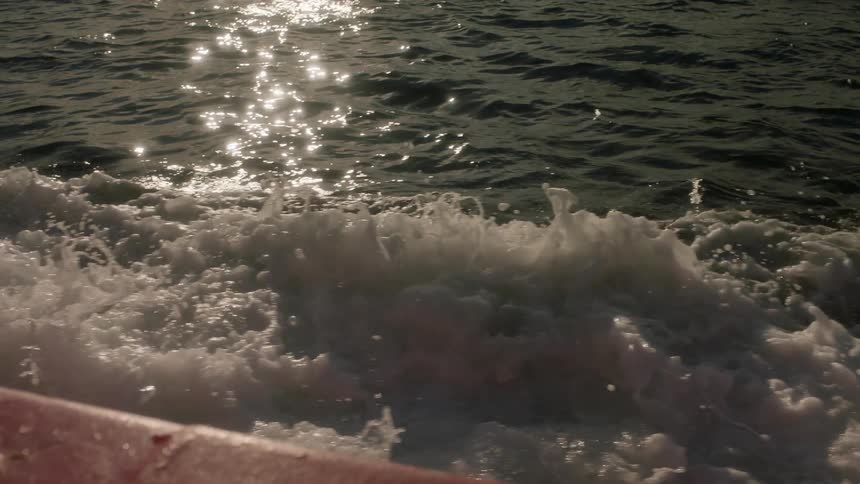 A boat travels through waves on the water