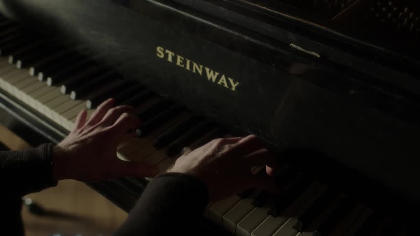 Person plays a large piano