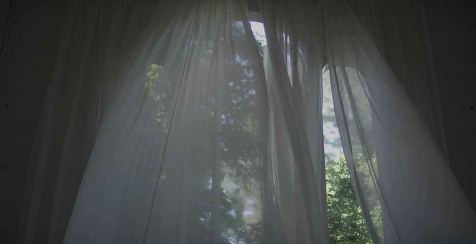 Curtains blow in a breeze