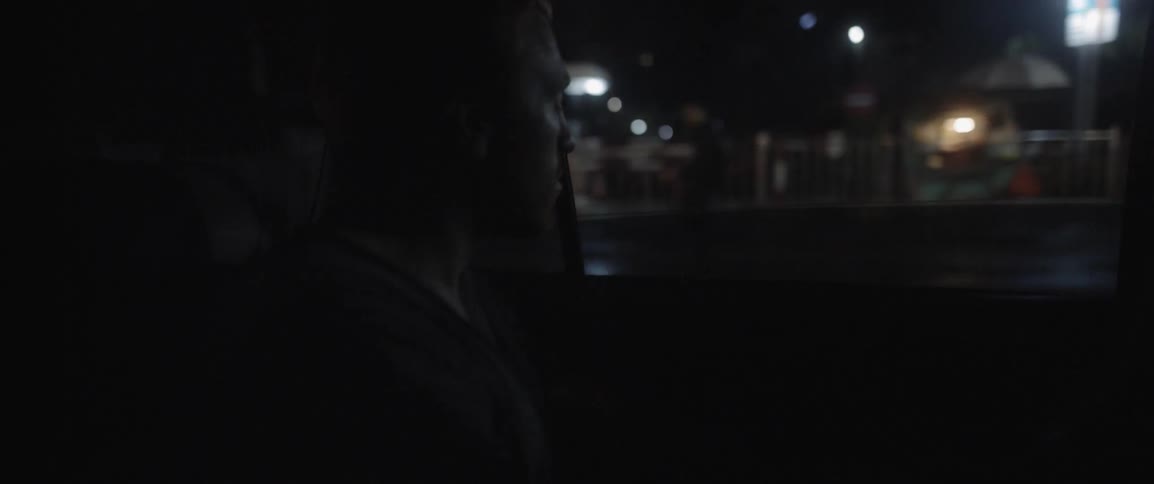 A man looks out of a window in a car