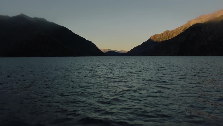 Rippling water stretches out to meet the mountains