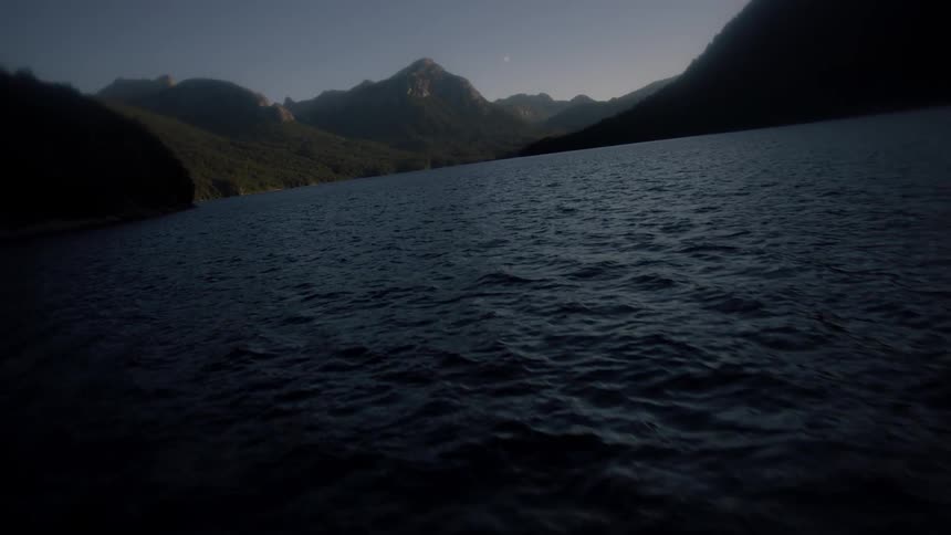 Water flowing in a lake surrounded by mountains