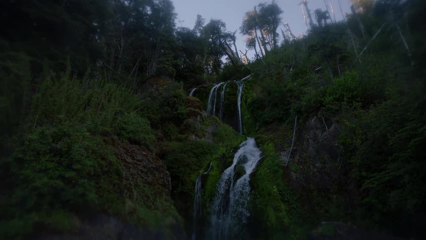 Water flows down a mountain to a lake below