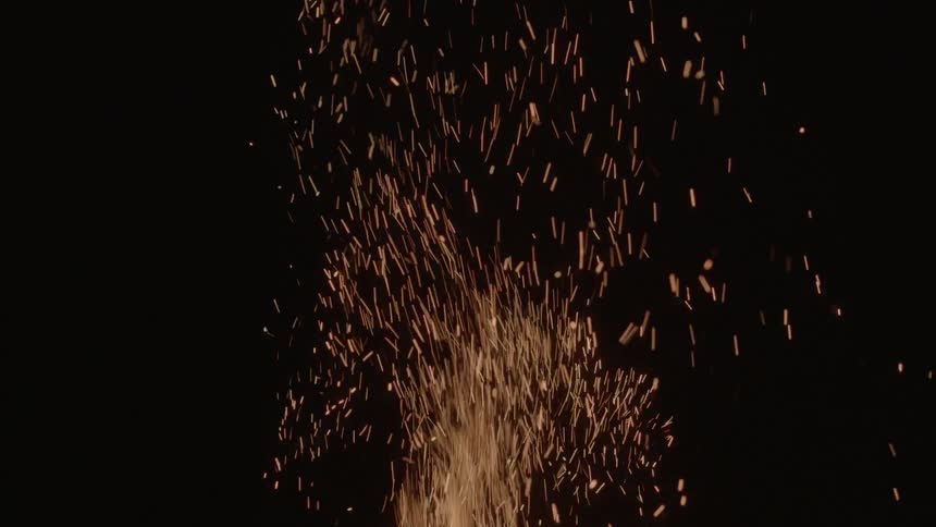 Fire sparks disappearing in a black background