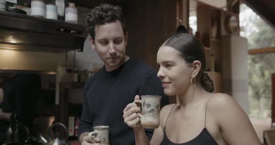 A man and woman talk and drink