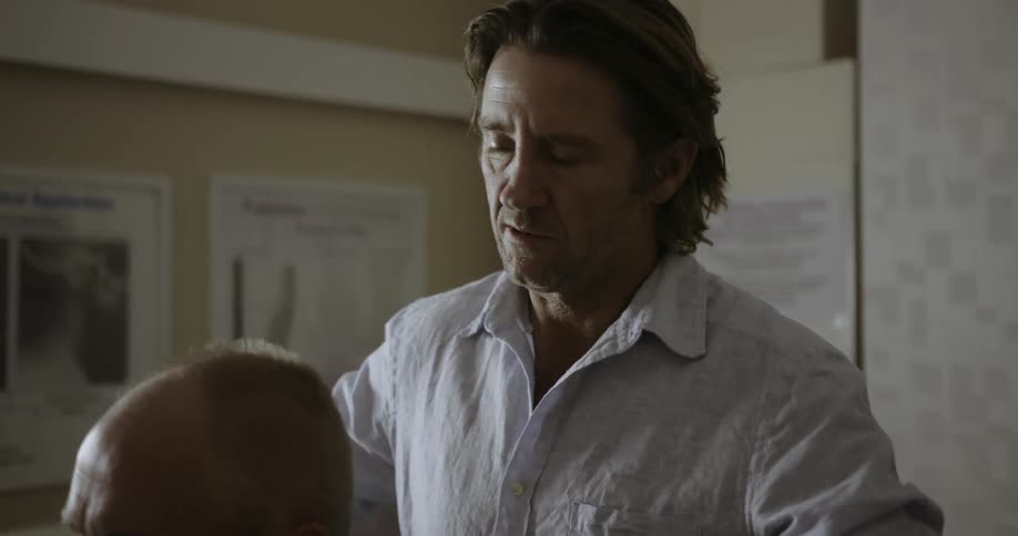Doctor adjusts a patient's shoulders and back
