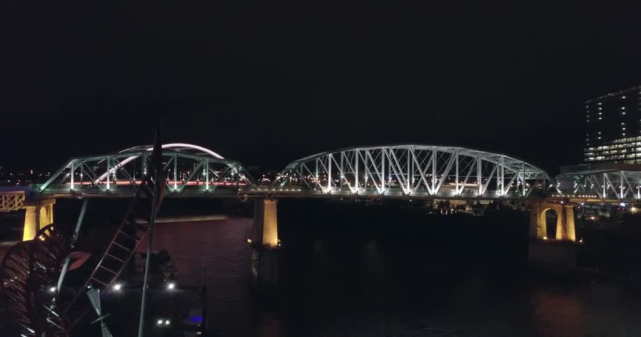A scenic view of a bridge at night