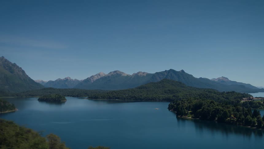 A mountain lake is shown on a clear day