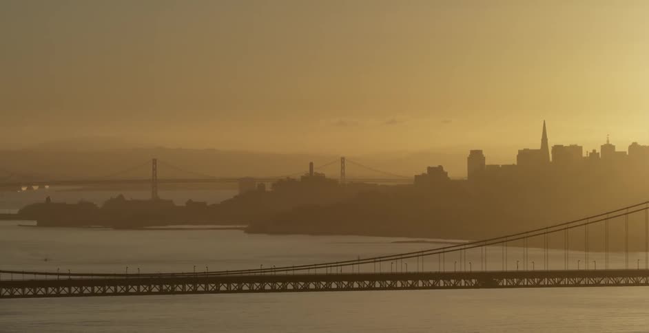A bridge sits over the water under a cloudy sky