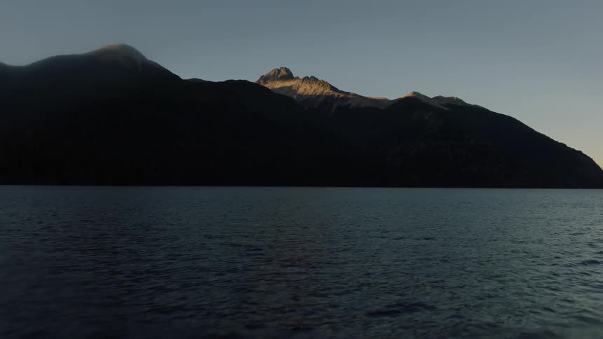 A mountain range being filmed from the water