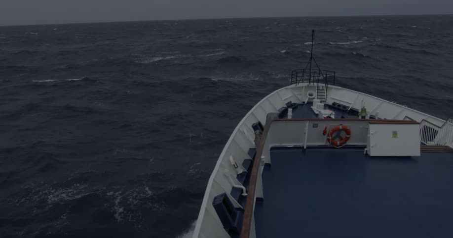 A ship travels through rough stormy ocean