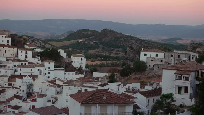Many white, red-roofed buildings spread out below