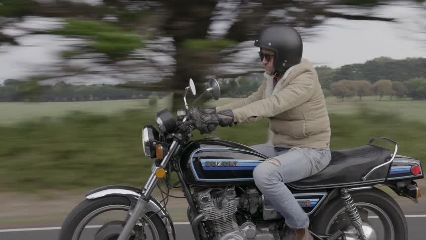 A man rides a motorcycle