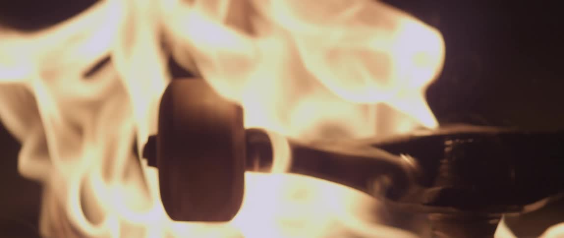 A fire burns a skateboard