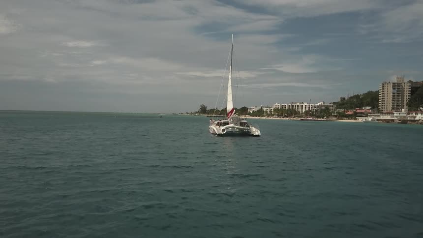 A boat is sailing near the shore