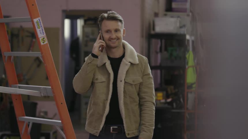 A man is walking around talking on a phone