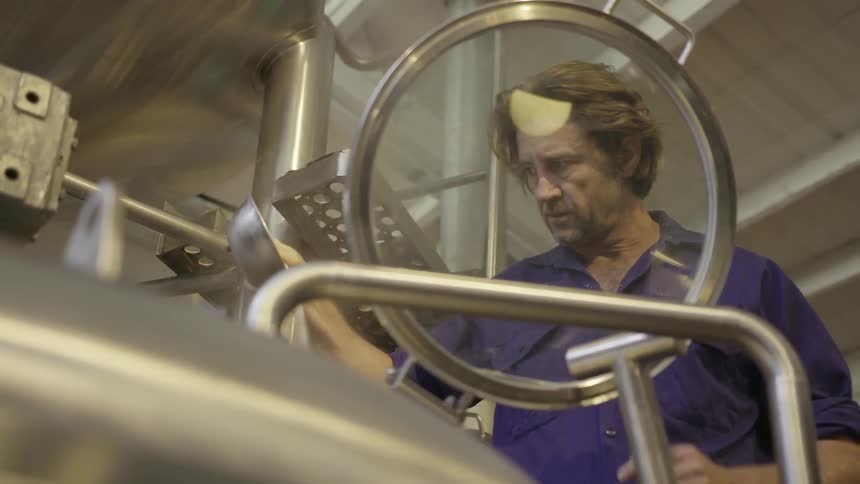A man pours a bowl into a still
